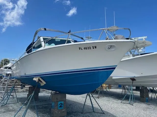 Slide: The Image of 1984 Bertram Express Moppie boat docked, named SEA JAY. - 8