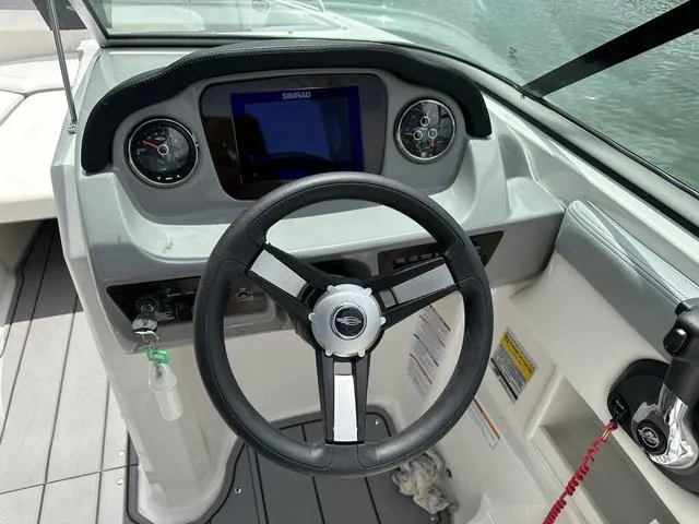 Slide: The Image of 2023 Chaparral 23 SSi boat dashboard with steering wheel and gauges. - 6