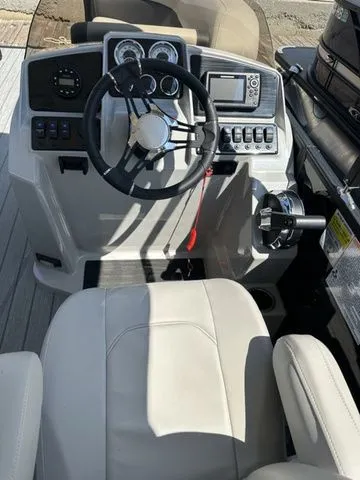 Slide: The Image of 2023 Sylvan Mirage X3 boat cockpit with steering wheel and control panel. - 4