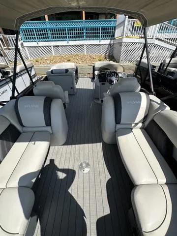 Slide: The Image of 2023 Sylvan Mirage X3 pontoon boat interior with spacious seating and modern design. - 3