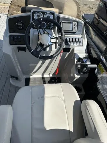 Slide: The Image of 2023 Sylvan Mirage X3 boat dashboard with steering wheel and control panel. - 4