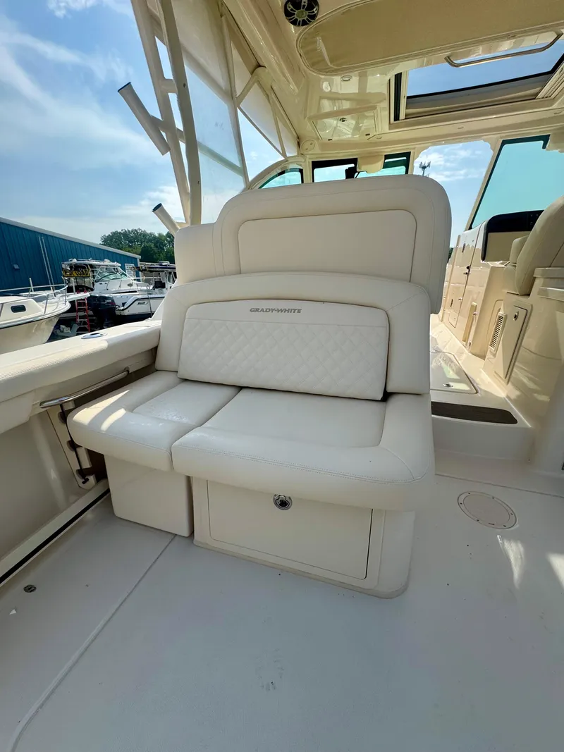 Slide: The Image of 2025 Grady-White Freedom 375 boat interior with white seating and storage compartment. - 10