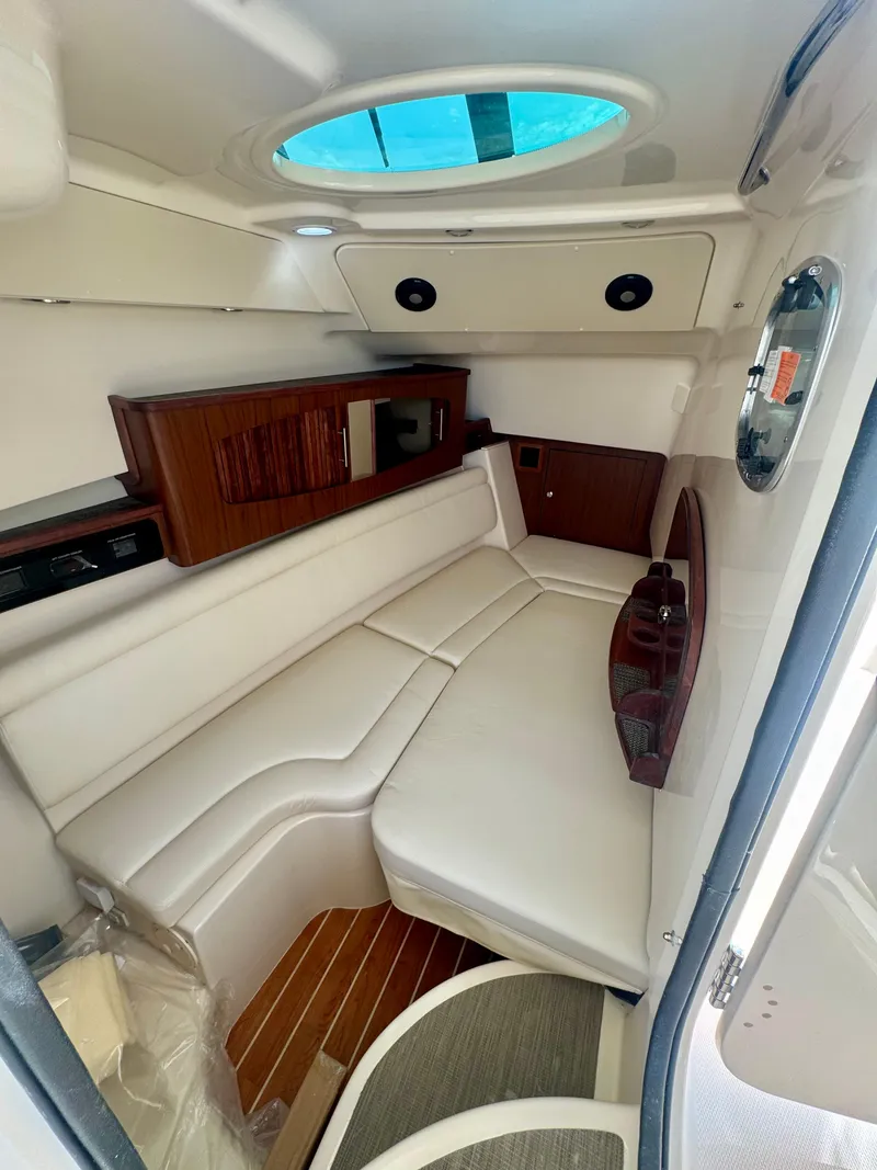 Slide: The Image of 2025 Grady-White Freedom 375 cabin interior with white seating and wood accents. - 12