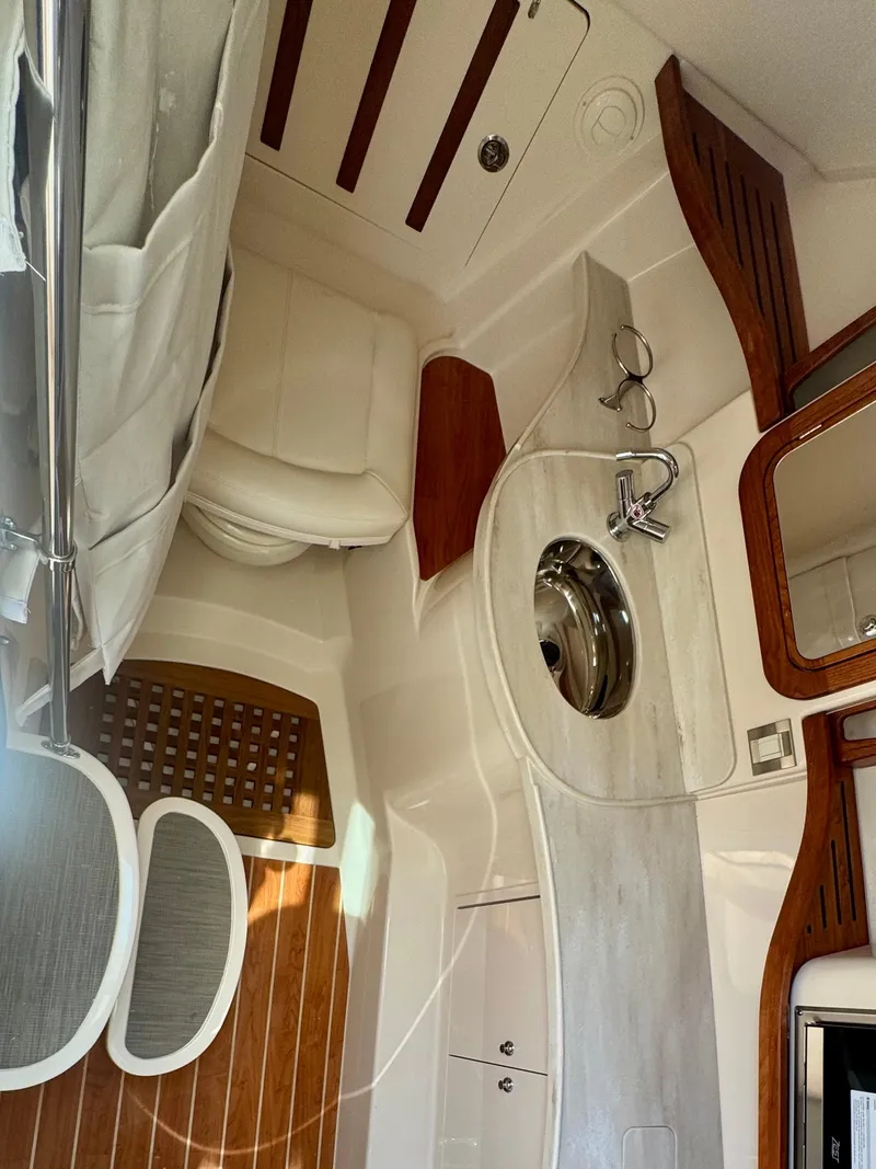 Slide: The Image of 2025 Grady-White Freedom 375 boat interior with sink and wooden accents. - 13