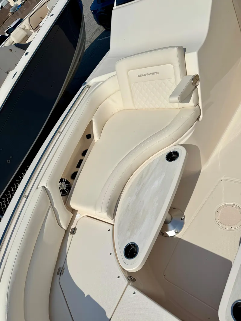 Slide: The Image of 2025 Grady-White Freedom 375 boat interior with cushioned seating and cup holders. - 17