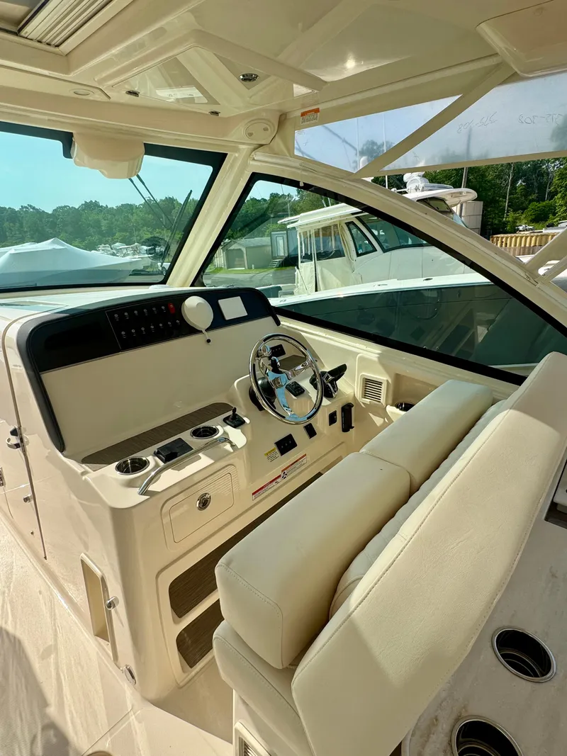 Slide: The Image of 2025 Grady-White Freedom 375 boat interior with steering wheel and control panel. - 5