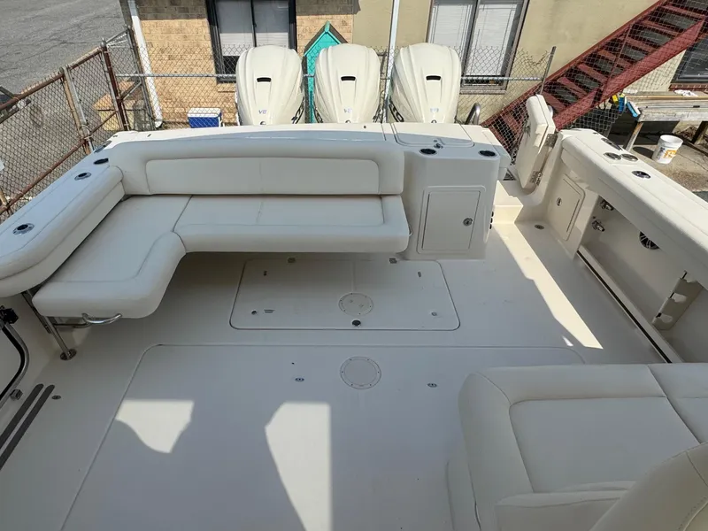 Slide: The Image of 2025 Grady-White Freedom 375 boat interior with white seating and spacious deck. - 8