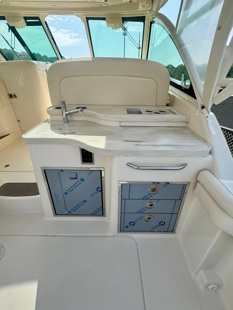Slide: The Image of 2025 Grady-White Freedom 375 boat interior with kitchenette and storage cabinets. - 9
