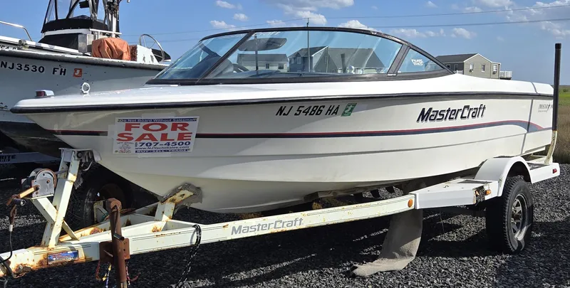 The Image of 1996 MasterCraft ProStar 190 boat for sale on trailer, white exterior, outdoor setting. - 0