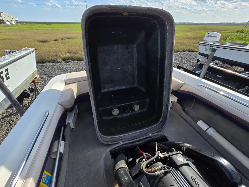 Slide: The Image of 1996 MasterCraft ProStar 190 boat interior with open engine compartment, showcasing engine details. - 10