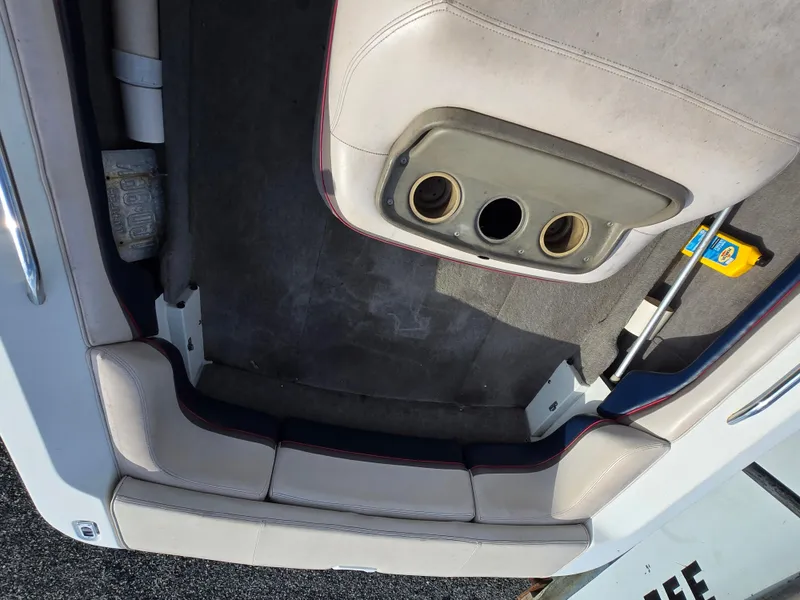 Slide: The Image of 1996 MasterCraft ProStar 190 interior with beige seating and cup holders. - 12