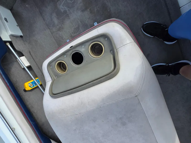 Slide: The Image of 1996 MasterCraft ProStar 190 interior with cup holders and carpeted flooring. - 13