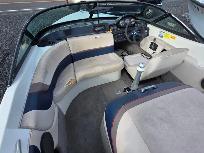 Slide: The Image of 1996 MasterCraft ProStar 190 interior with beige and navy seating, steering wheel, and dashboard. - 15