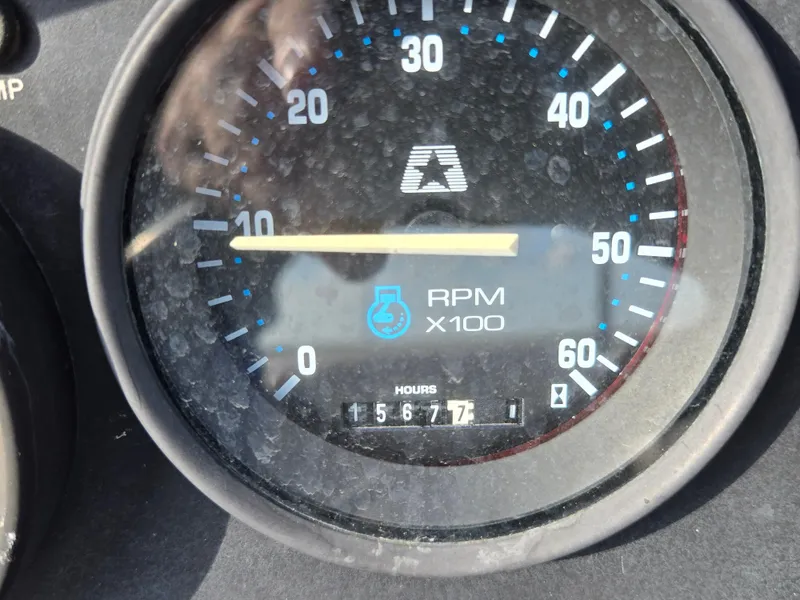 Slide: The Image of 1996 MasterCraft ProStar 190 tachometer showing 1567.7 hours and RPM gauge. - 16