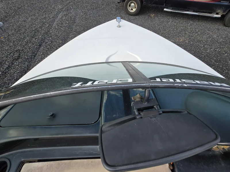 Slide: The Image of 1996 MasterCraft ProStar 190 boat, view from the bow, parked on gravel. - 17