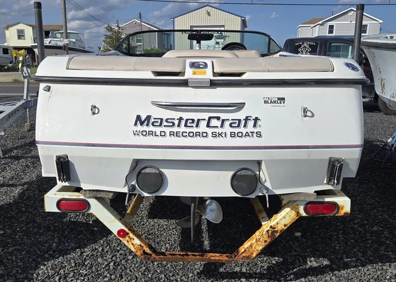 Slide: The Image of 1996 MasterCraft ProStar 190 ski boat, rear view, on a trailer, parked outdoors. - 4
