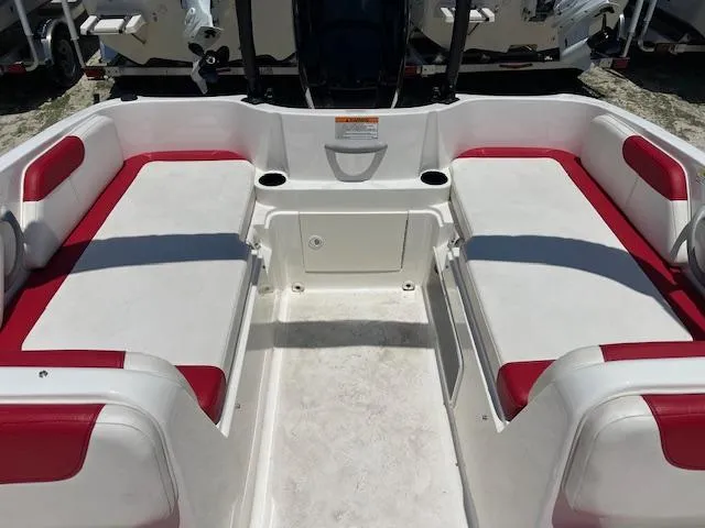 Slide: The Image of 2016 Bayliner Element XL boat interior with red and white seating. - 2