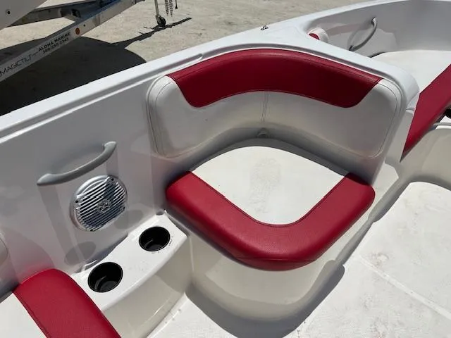 Slide: The Image of 2016 Bayliner Element XL boat interior with red and white seating and cup holders. - 5