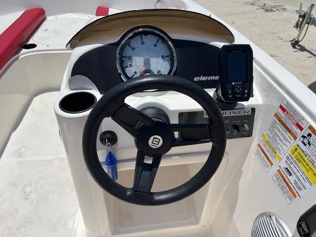 Slide: The Image of 2016 Bayliner Element XL dashboard with steering wheel and gauges. - 6