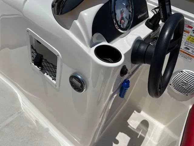 Slide: The Image of 2016 Bayliner Element XL boat dashboard with steering wheel and controls. - 7