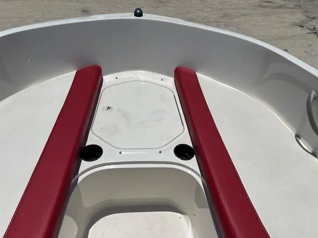 Slide: The Image of 2016 Bayliner Element XL boat interior with red seating and cup holders. - 9