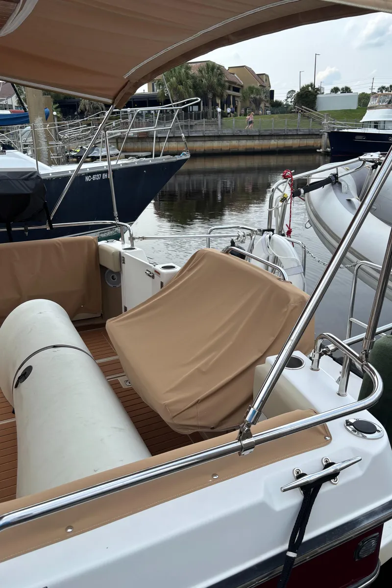 Slide: The Image of 2019 Ranger Tugs R-29 CB boat with covered seating, docked in a marina. - 10