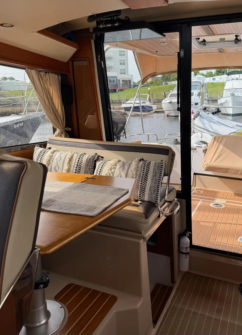 Slide: The Image of Interior of 2019 Ranger Tugs R-29 CB yacht with dining area and marina view. - 34
