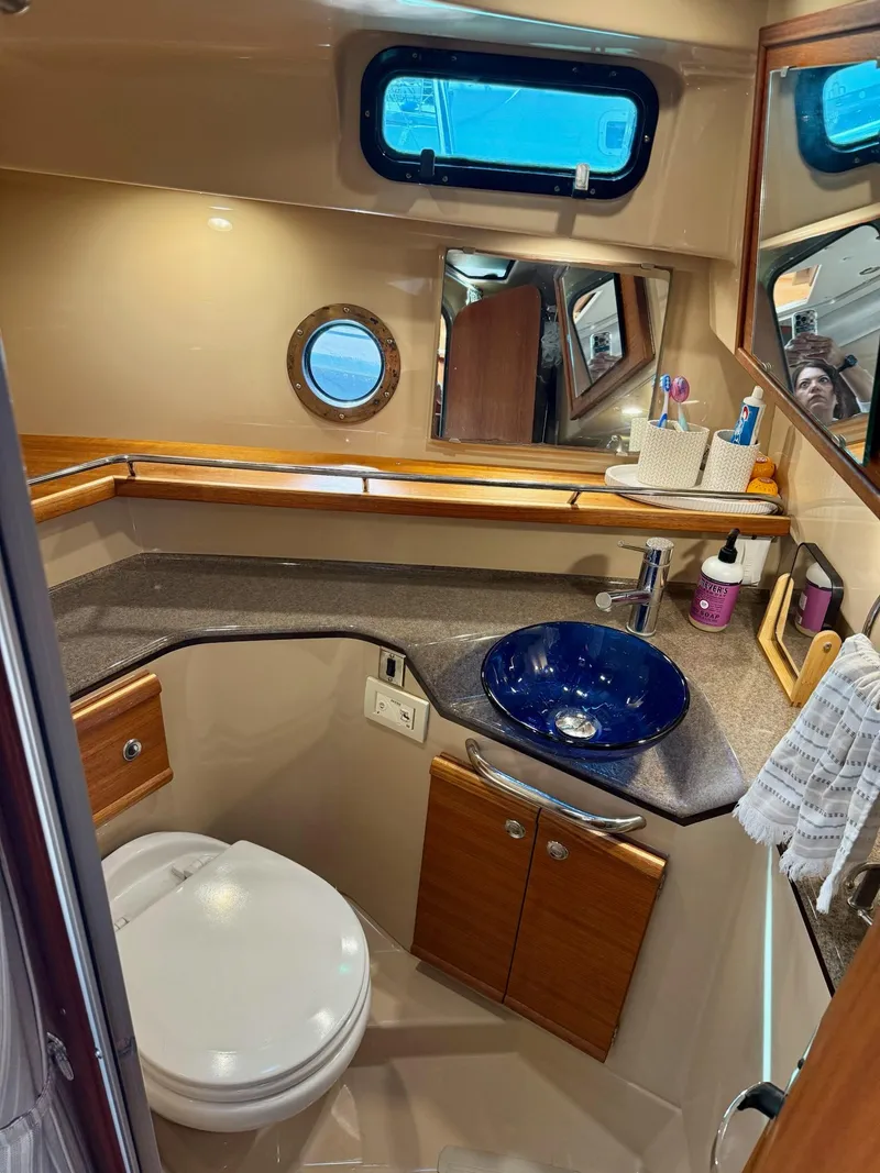 Slide: The Image of 2019 Ranger Tugs R-29 CB bathroom with modern fixtures and blue glass sink. - 39