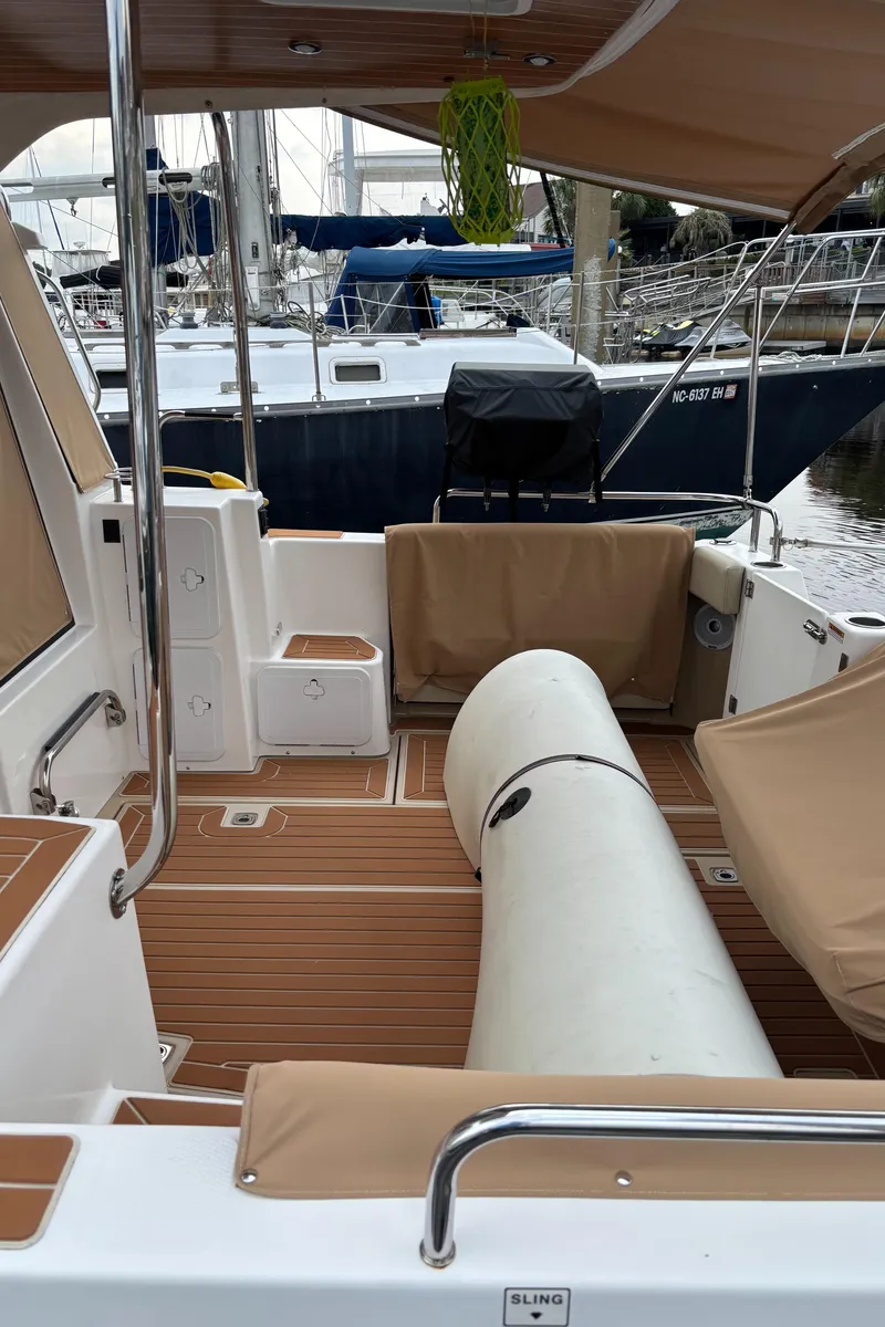 Slide: The Image of 2019 Ranger Tugs R-29 CB boat interior with tan seating and wood flooring. - 8