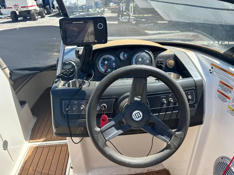 Slide: The Image of Steering console of a 2016 Bayliner 215 Deck Boat with navigation system and gauges. - 3