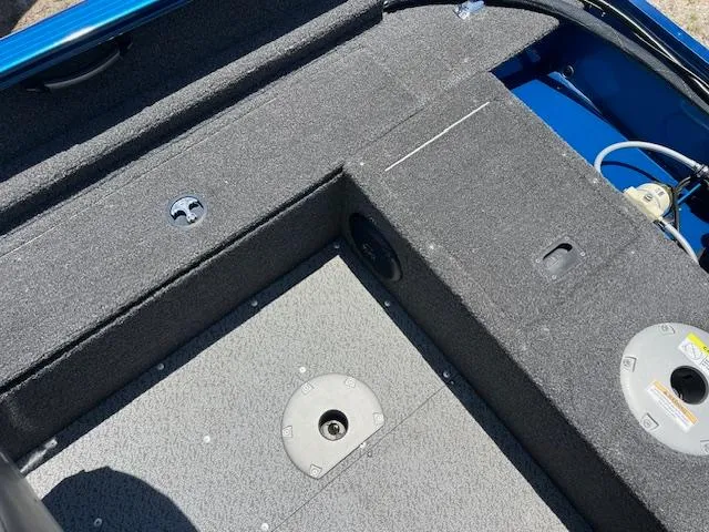 Slide: The Image of Interior view of a 2022 Lund 1650 Angler SS boat, featuring carpeted flooring and storage compartments. - 4