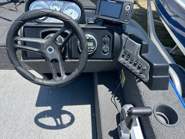 Slide: The Image of 2022 Lund 1650 Angler SS boat dashboard with steering wheel and control panel. - 5