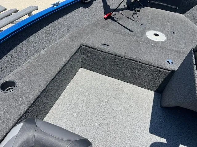 Slide: The Image of 2022 Lund 1650 Angler SS boat interior with gray carpet and seating area. - 6
