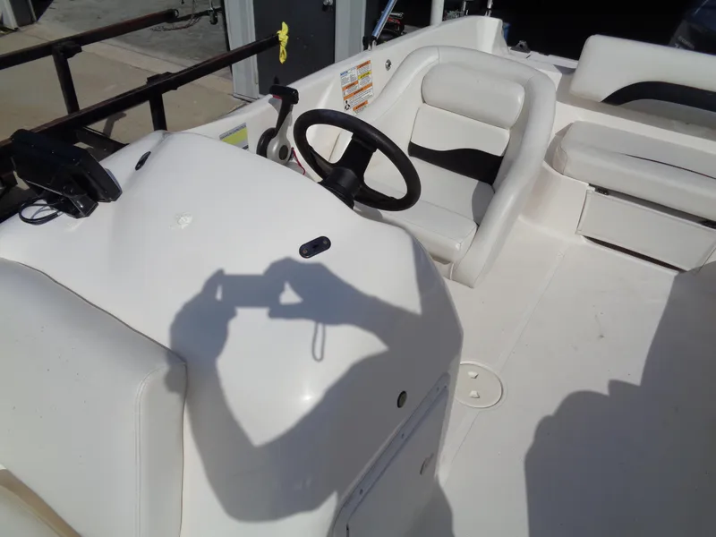 Slide: The Image of 2010 Hurricane FunDeck GS 188 OB boat interior with steering wheel and seating. - 10