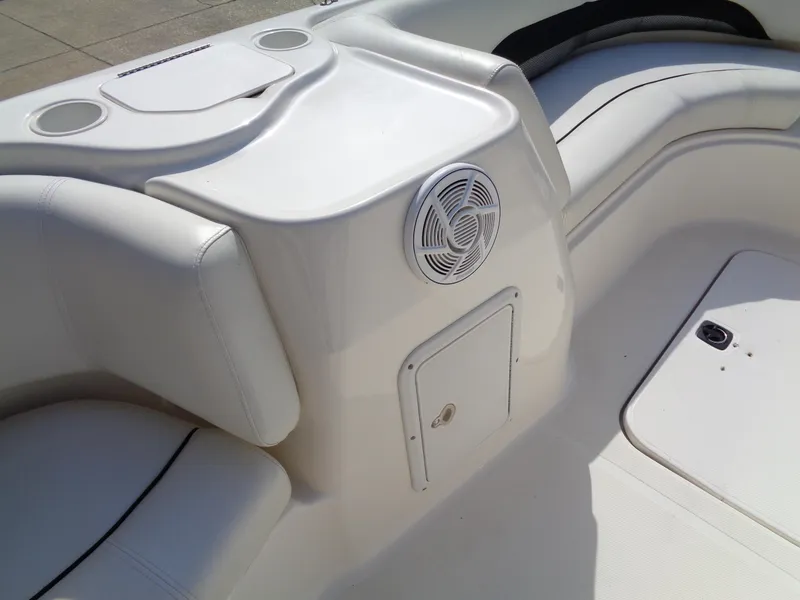 Slide: The Image of 2010 Hurricane FunDeck GS 188 OB boat interior with white seating and speaker. - 13