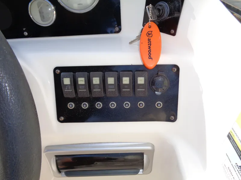 Slide: The Image of Control panel of 2010 Hurricane FunDeck GS 188 OB boat with switches and key. - 17