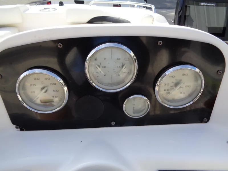 Slide: The Image of Dashboard of 2010 Hurricane FunDeck GS 188 OB with gauges and controls. - 18