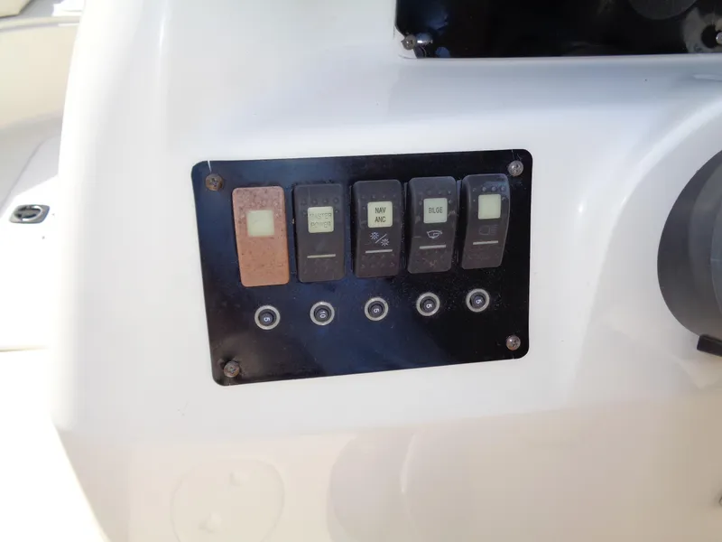Slide: The Image of Control panel of 2010 Hurricane FunDeck GS 188 OB boat with switches and buttons. - 19