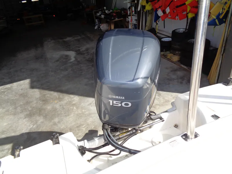 Slide: The Image of Outboard motor on 2010 Hurricane FunDeck GS 188 OB boat in a garage setting. - 20