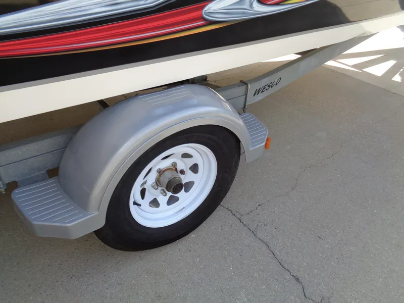 Slide: The Image of Trailer wheel of 2010 Hurricane FunDeck GS 188 OB boat on concrete surface. - 23