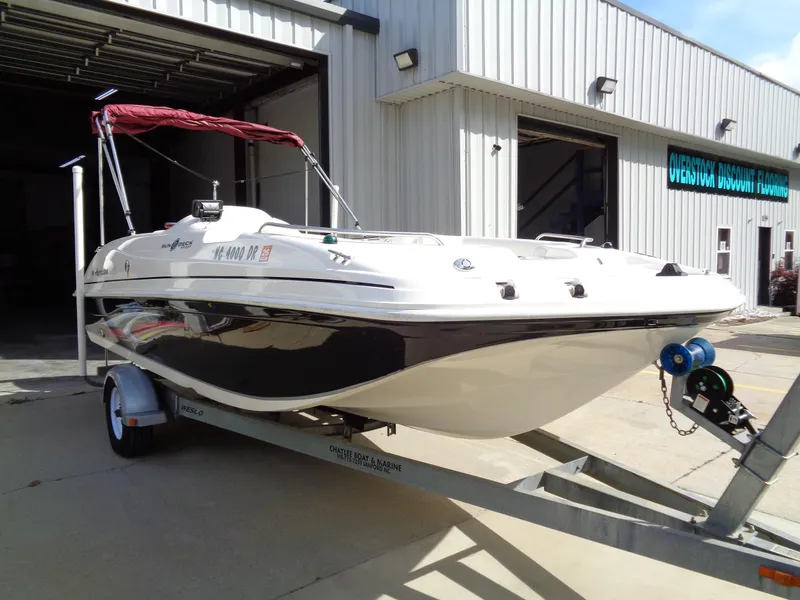 Slide: The Image of 2010 Hurricane FunDeck GS 188 OB boat on trailer outside a building. - 3