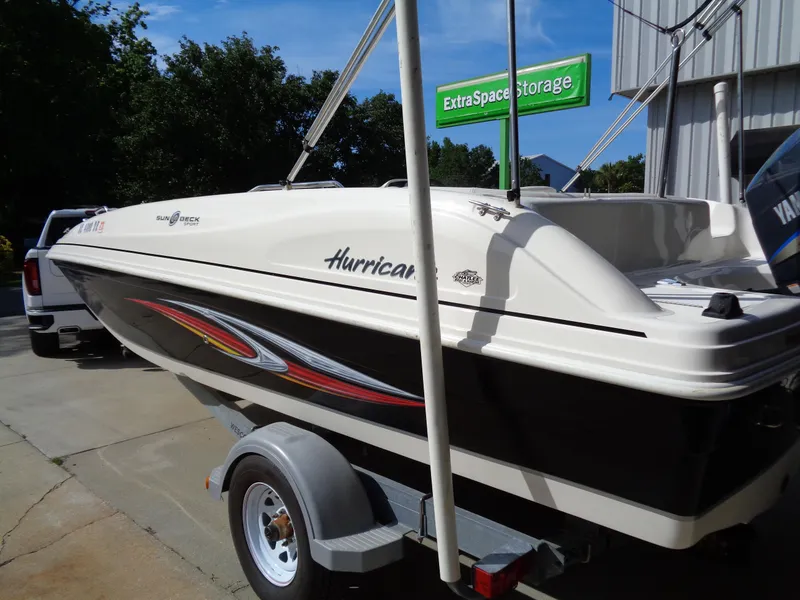 Slide: The Image of 2010 Hurricane FunDeck GS 188 OB boat on trailer near storage facility. - 6