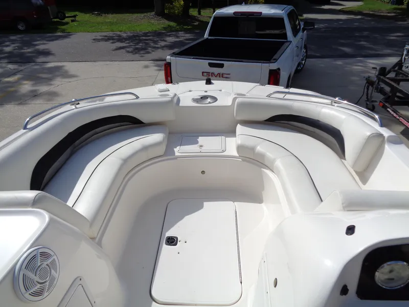 Slide: The Image of 2010 Hurricane FunDeck GS 188 OB boat interior with seating, parked near a GMC truck. - 7