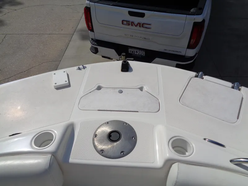 Slide: The Image of 2010 Hurricane FunDeck GS 188 OB boat deck with GMC vehicle in background. - 8