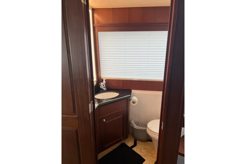 Slide: The Image of Luxurious bathroom in 2006 Pacific Mariner 85 yacht with wood cabinetry and modern fixtures. - 11