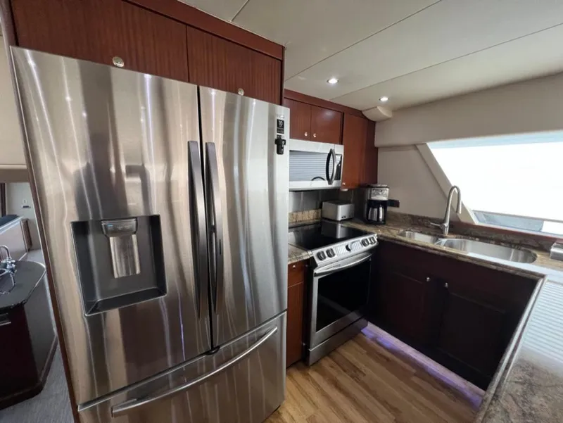 Slide: The Image of Luxurious kitchen in 2005 Pacific Mariner 85 yacht with stainless steel appliances. - 12