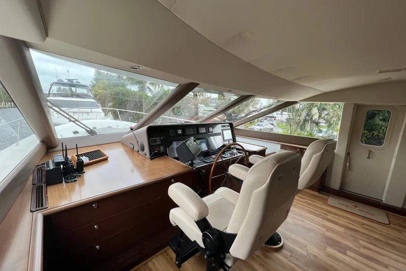 Slide: The Image of Interior helm of 2006 Pacific Mariner 85 yacht with navigation equipment and seating. - 23
