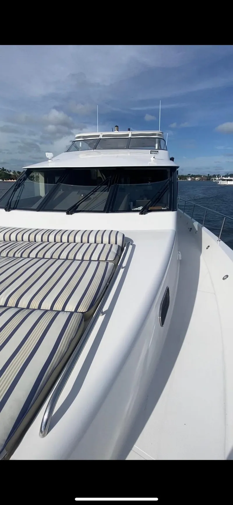 Slide: The Image of 2005 Pacific Mariner 85 yacht with striped deck cushions on a sunny day. - 3