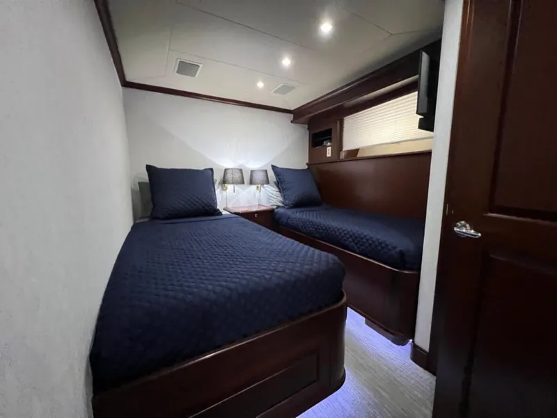 Slide: The Image of Luxurious twin cabin in 2005 Pacific Mariner 85 yacht with elegant wood finishes. - 39