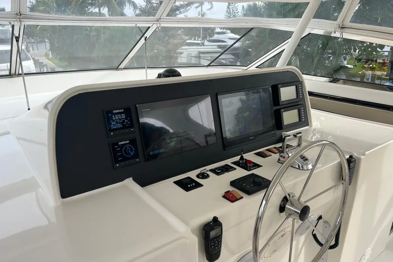 Slide: The Image of Control panel of a 2006 Pacific Mariner 85 yacht with navigation equipment and steering wheel. - 41